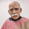 A realistic latex mask of an old man with a bald head, white mustache, and wrinkled skin.