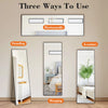 Three ways to use an arched full-length floor mirror with an aluminum frame: horizontally, standing, and hanging.