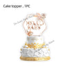 A white cake topper featuring the text MELLO BABY surrounded by floral accents.