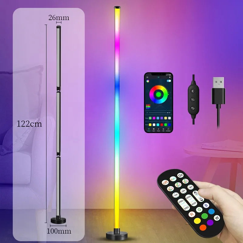 A tall, slender smart RGB floor lamp with a vertical light display and a remote control is shown next to a smartphone.