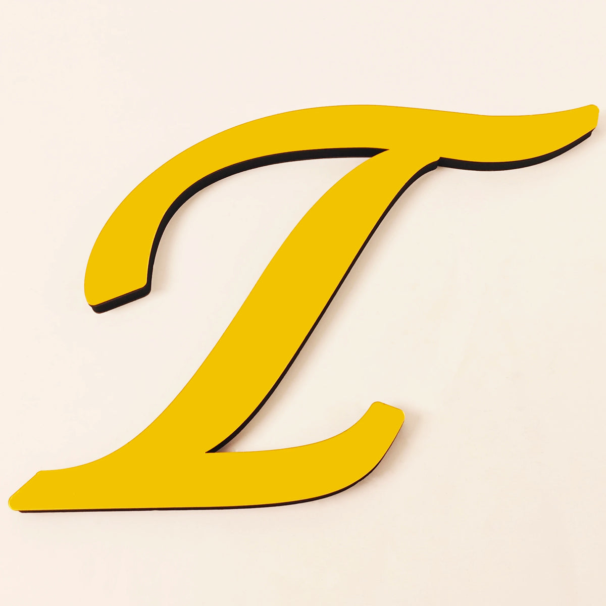 A yellow 3D acrylic letter T wall sticker on a light background.