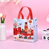 A light blue non-woven gift tote bag with festive Christmas prints featuring houses, reindeer, and holiday decorations.