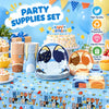 A set of blue dog themed party supplies including plates cups napkins and a cake for a birthday celebration