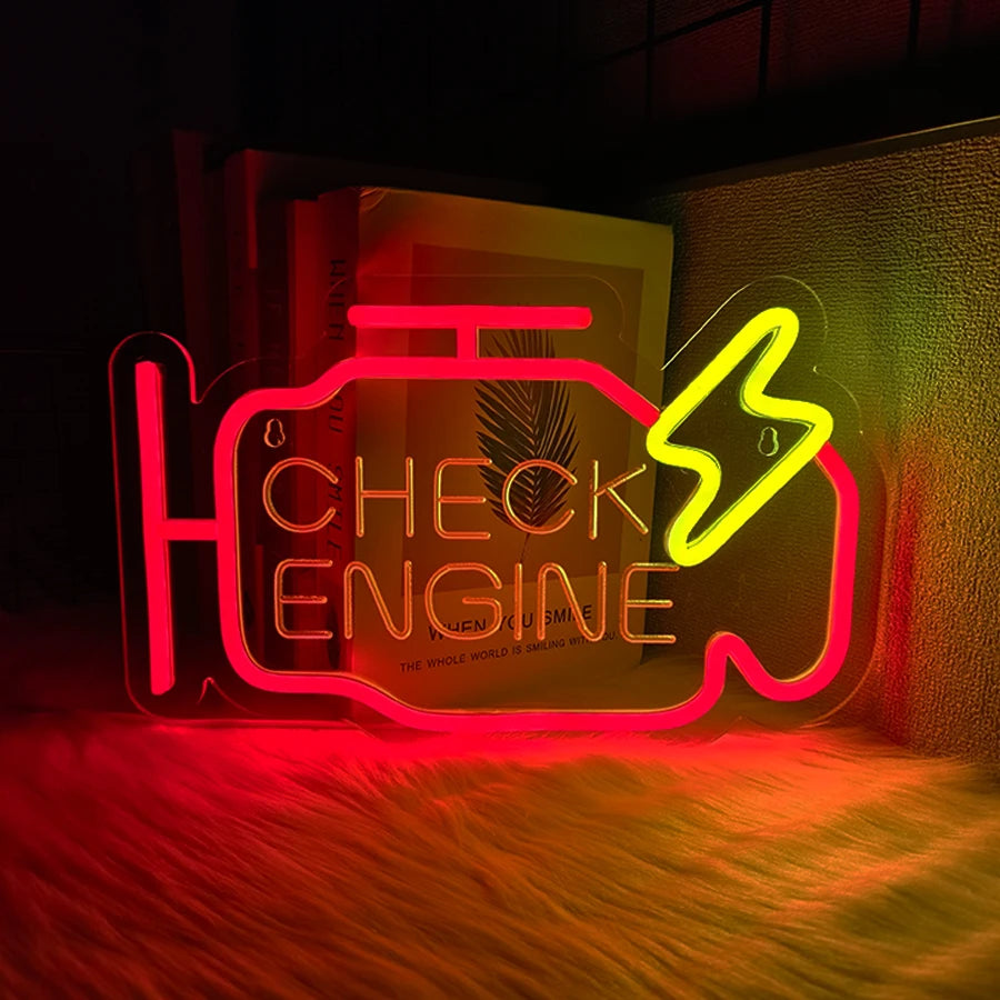Neon sign shaped like an engine with the text CHECK ENGINE glowing red and yellow on a textured surface.