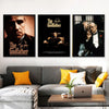 A set of three black and white canvas prints featuring scenes from The Godfather displayed on a white wall.