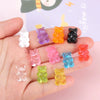 A hand holds a set of ten bear-shaped magnetic chalkboard and message stickers in various colors like white, purple, orange, 