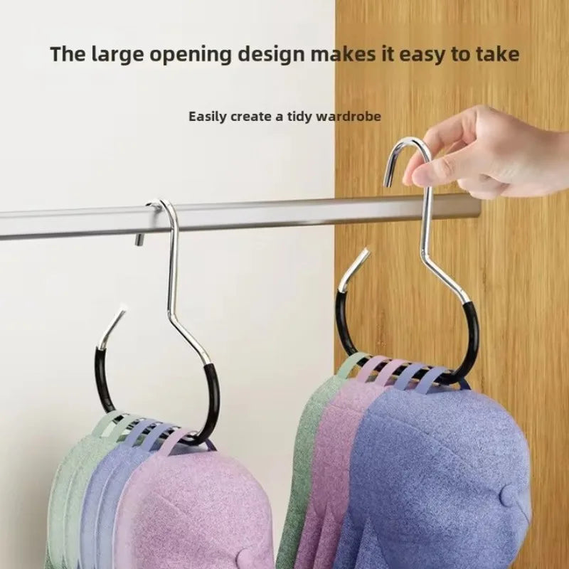 A close-up of a hat organizer rack with a large opening design hanging on a closet rod, displaying various colored hats.