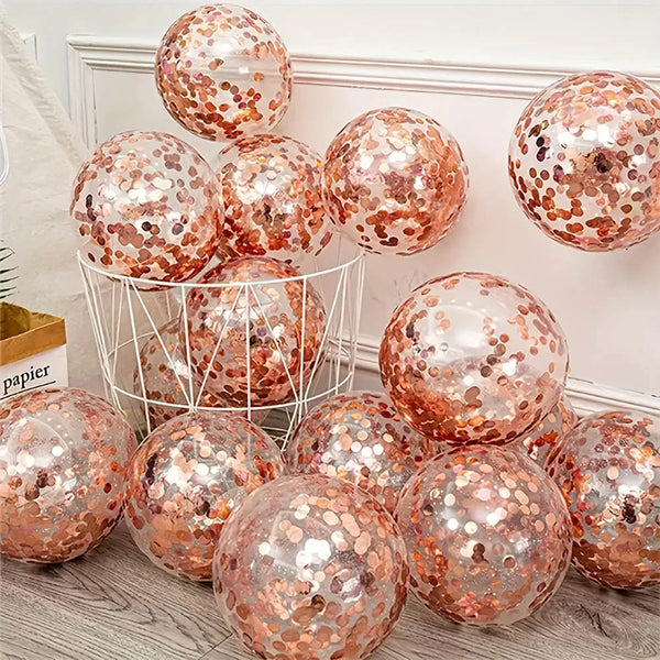 A collection of rose gold sequin balloons in various sizes displayed on a white wire rack.