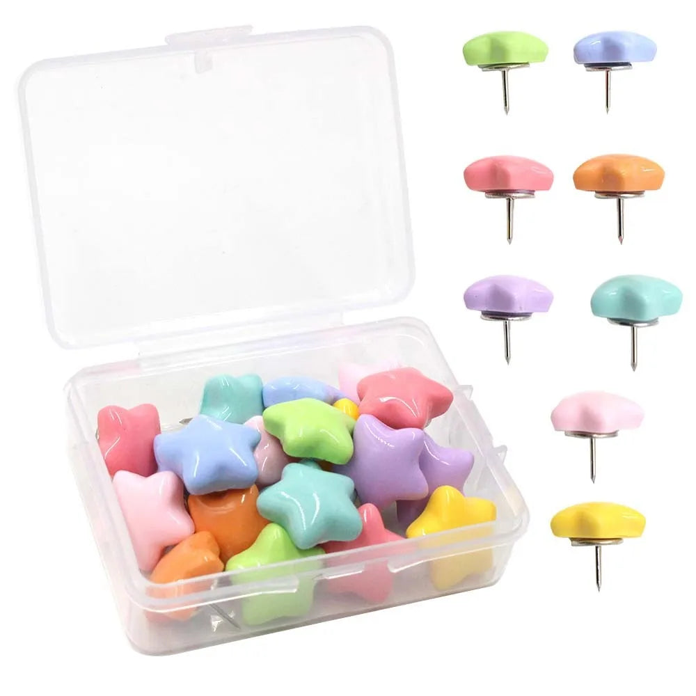 A clear storage box containing various colored decorative pentagram thumb tacks for crafting and display.