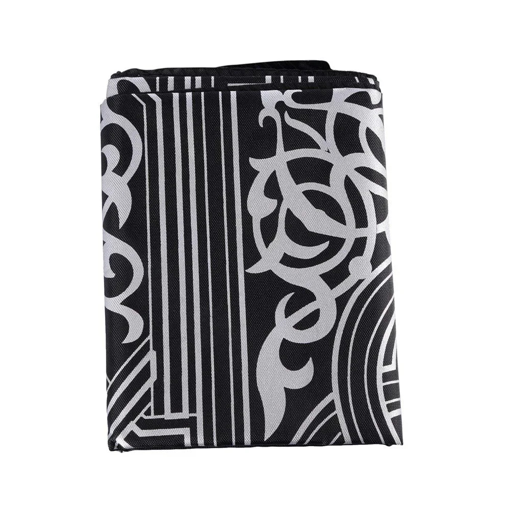 Black and white patterned portable travel prayer mat with compass.
