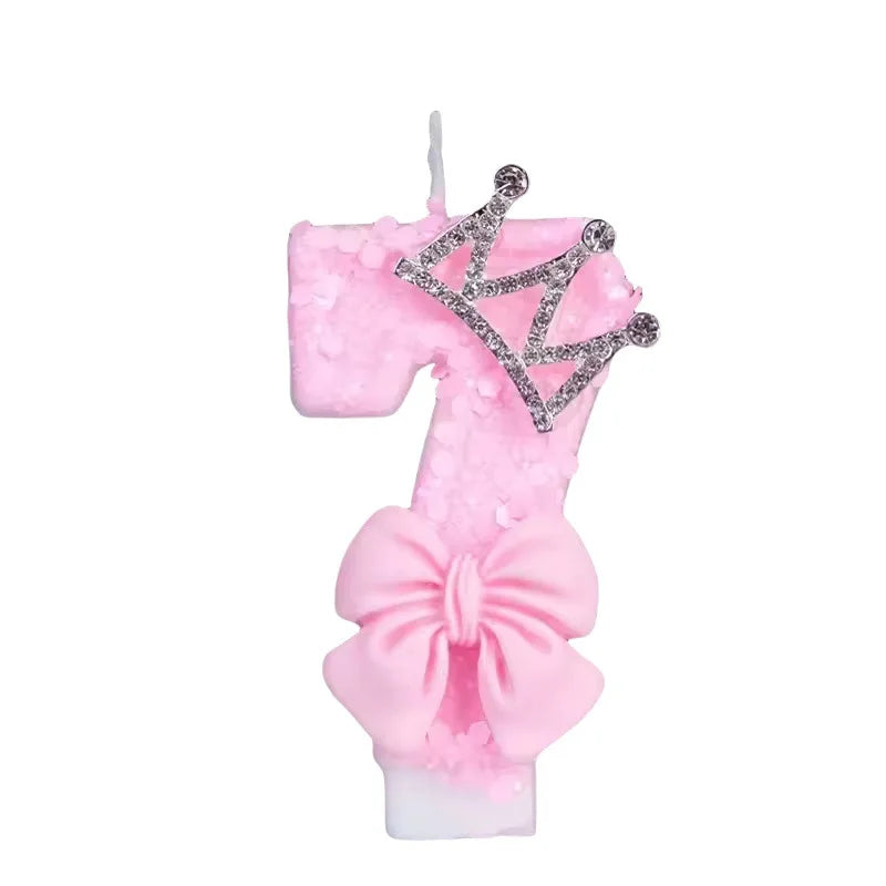 Pink princess birthday candle with a crown topper and bow decoration