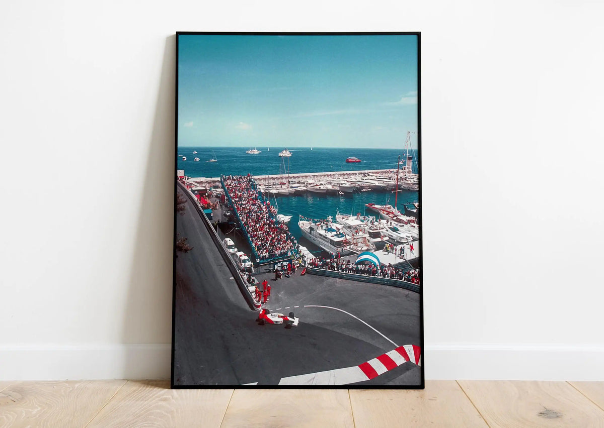 A canvas print depicting a motorsport racing track view from above, showing cars on the track and a large port with ships.