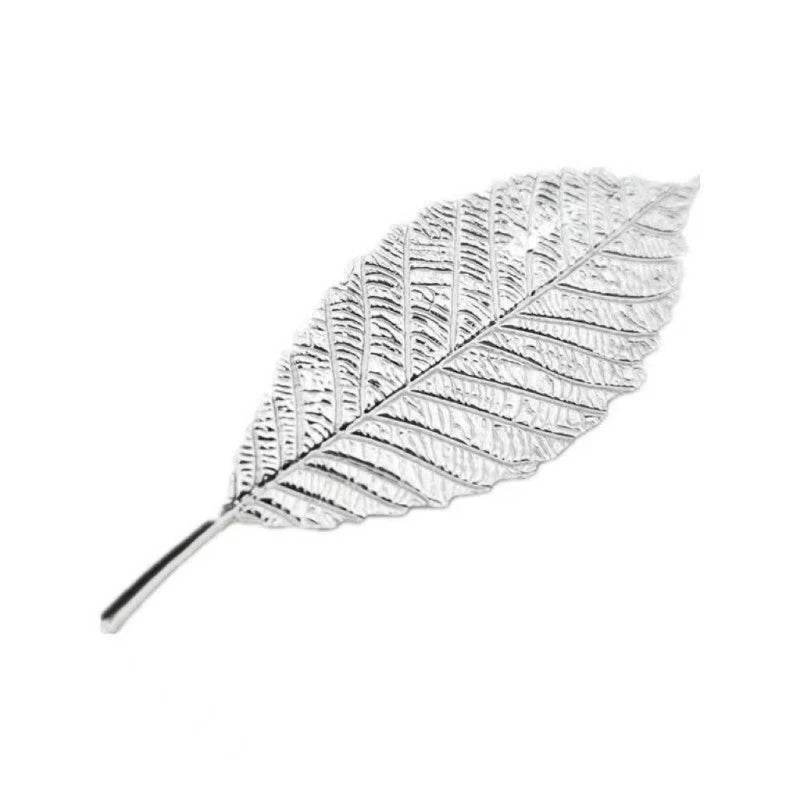 A delicate sterling silver tea brewing leaf with intricate veining.