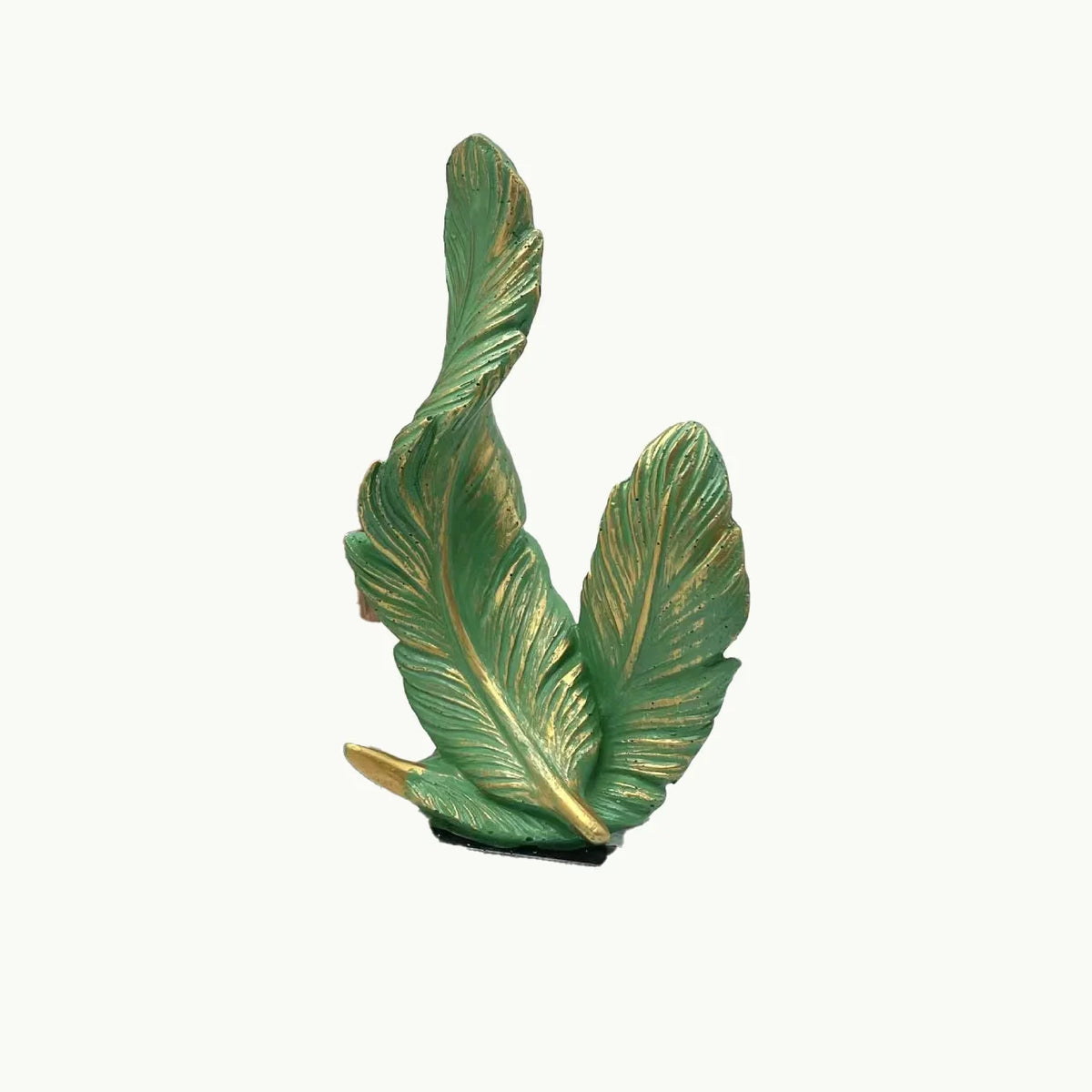 A sculpted feather in a vibrant green color used as a centerpiece.