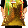 A person holds a shiny gold Christmas drawstring gift bag with a red ribbon and a tag.