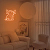 A living room scene featuring a neon sign shaped like a Highland cow on the wall and a large round light fixture.