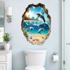 A wall sticker featuring a mural of dolphins jumping through a broken, natural-looking wall frame on a light blue wall.