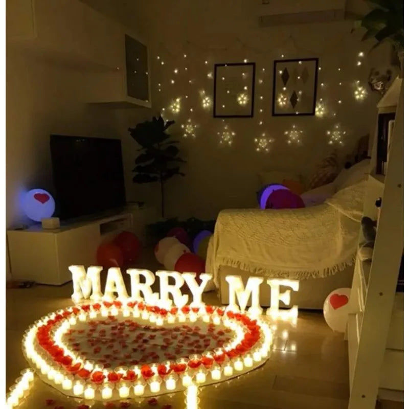 A decorative display featuring heart-shaped LED tealight candles arranged on the floor.