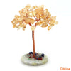 Natural crystal money tree decor featuring amber-colored crystals on a copper wire stem and mossy base