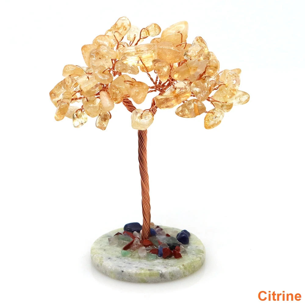 Natural crystal money tree decor featuring amber-colored crystals on a copper wire stem and mossy base