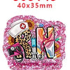 Pink glitter acrylic charms shaped like the letters SN for nurse-themed crafts