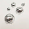A collection of silver disco balls of various sizes arranged on a white background.