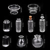 A collection of miniature glass items including a bowl, a bottle, and various shaped vessels.