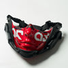 A red and black half face mask with a stylized face design is shown against a white background.