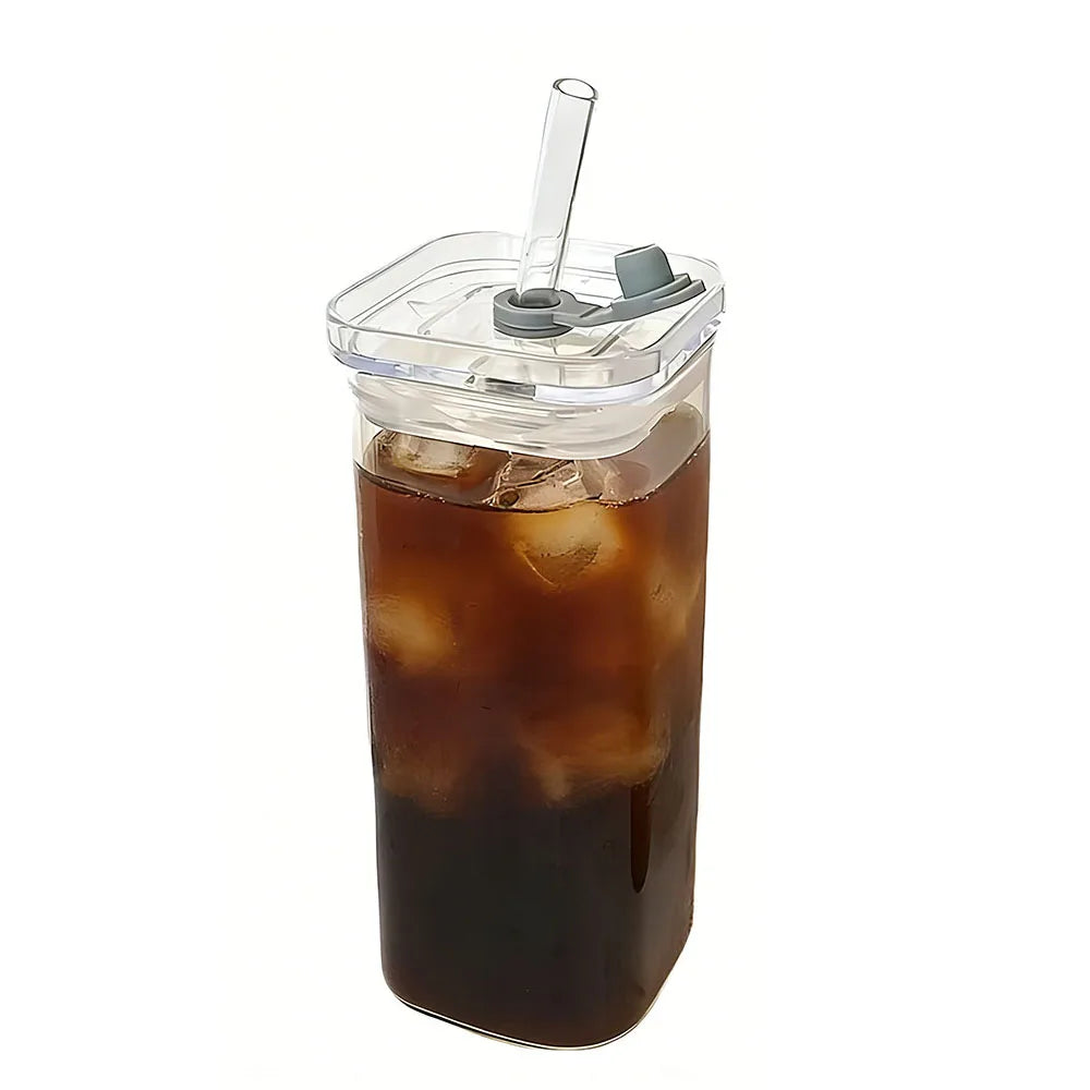 A tall glass of iced coffee in a clear plastic cup with a lid and straw.