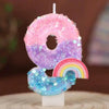 A pink and purple sequined number eight candle with a rainbow-colored base on a white stand.