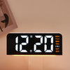 A black digital alarm clock displaying 12:20 with an orange mood light and days of the week visible.