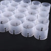 A collection of clear plastic balloon arch connector rings for party decor arranged in rows.