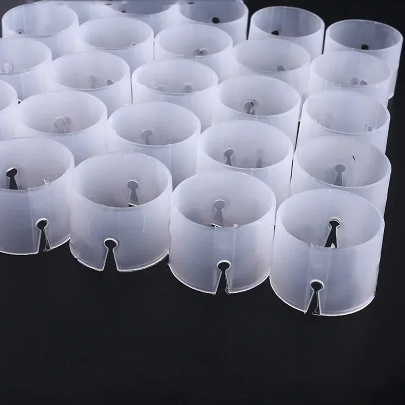 A collection of clear plastic balloon arch connector rings for party decor arranged in rows.