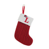 A red knitted sock with a white tag featuring the letter L and a red string for hanging.