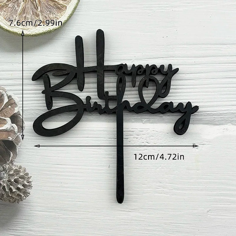 Black acrylic birthday cake topper with the words Happy Birthday on a stick
