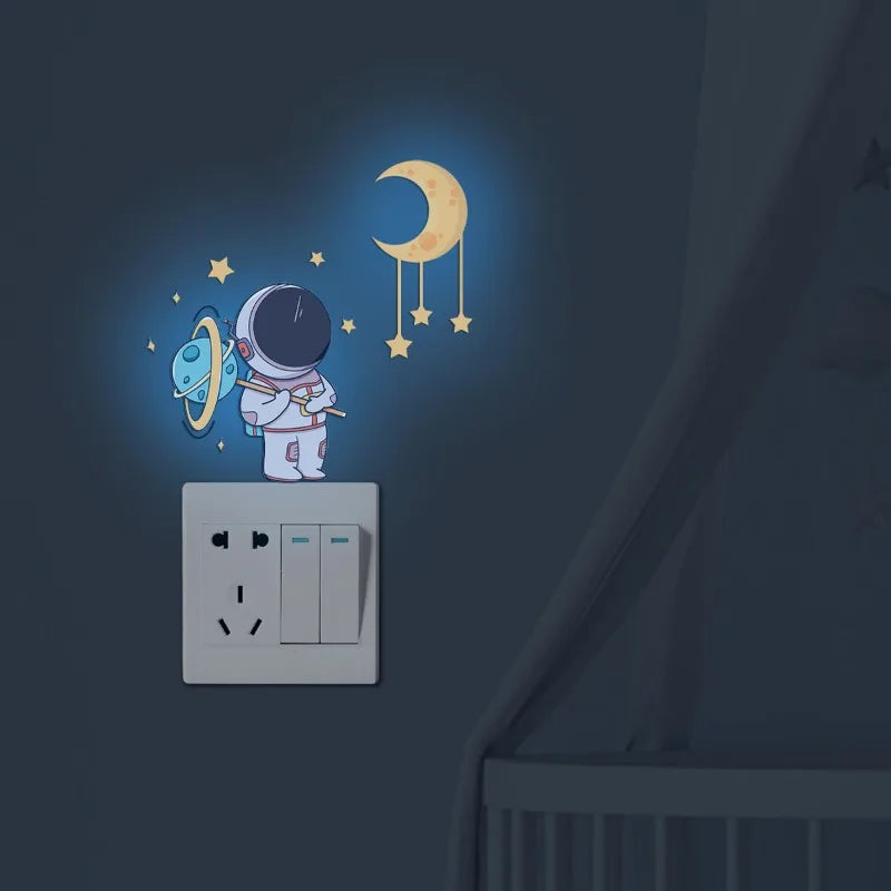Wall stickers featuring an astronaut, stars, and a crescent moon on a light blue background.
