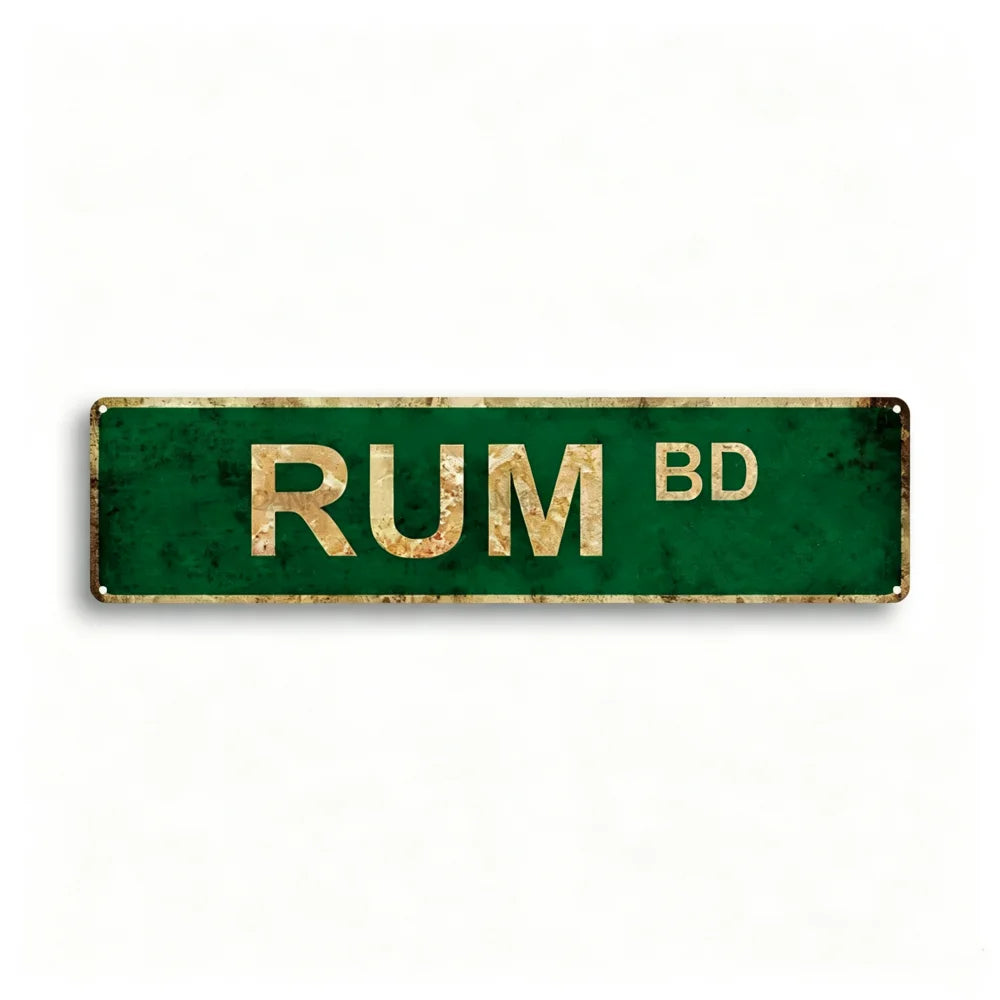 A rectangular, distressed green metal tin sign with the text RUM BD stamped in gold letters.