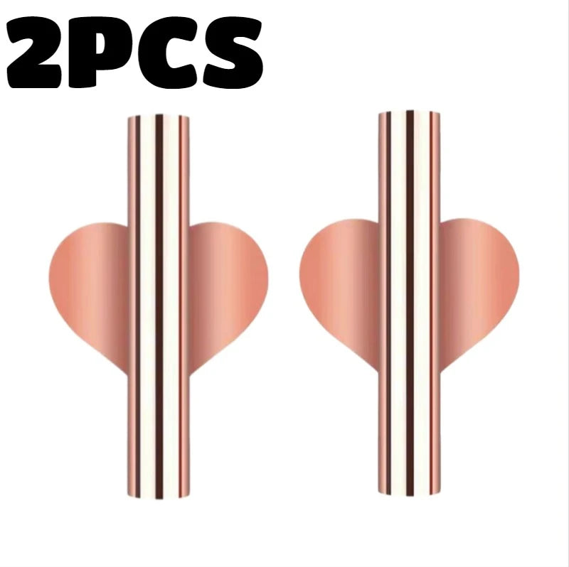 A pair of modern wall-mounted flower vases with a rose gold finish and striped design.