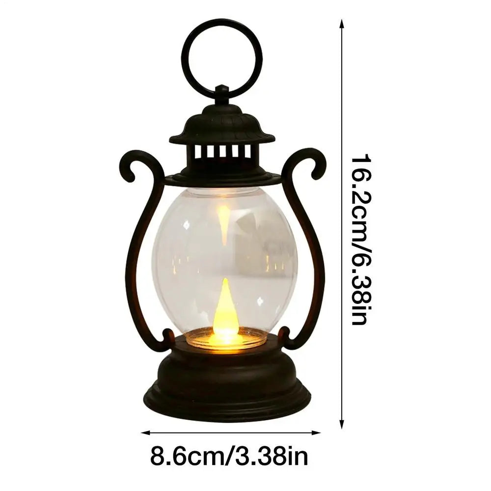 A black retro battery-powered desk lamp with a clear glass globe and decorative metalwork.