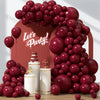 A large arrangement of deep burgundy latex balloons forming a decorative arch and cluster.