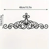 Black wrought iron wall art featuring an ornate Bismillah design