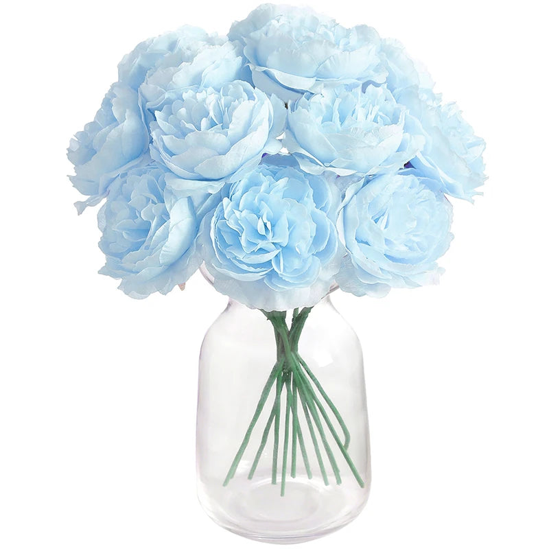 A bouquet of six light blue peony flowers in a clear glass vase.