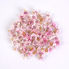 A cluster of pink and white silk artificial flower heads used for weddings, crafts, and home decor.