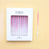 A white box for a set of 24 pink and purple birthday candles with a pink matchstick visible.