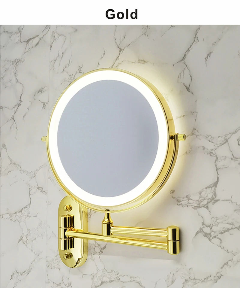 A round gold illuminated makeup mirror mounted on a marble wall.