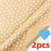 Roll of festive snowflake Christmas wrapping paper in beige with white polka dots