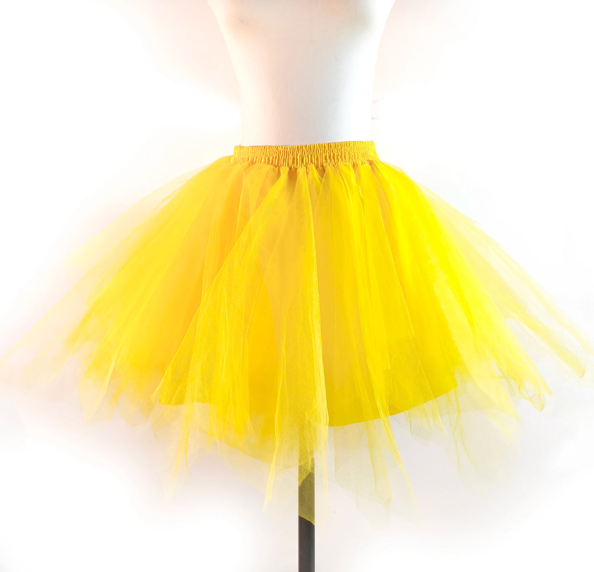 Yellow tulle tutu skirt displayed on a mannequin.