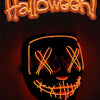 A glowing orange LED Halloween mask featuring a carved skull face and teeth, set against a dark background.