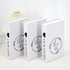 A set of three modern decorative fake books in white with black text and heart accents.