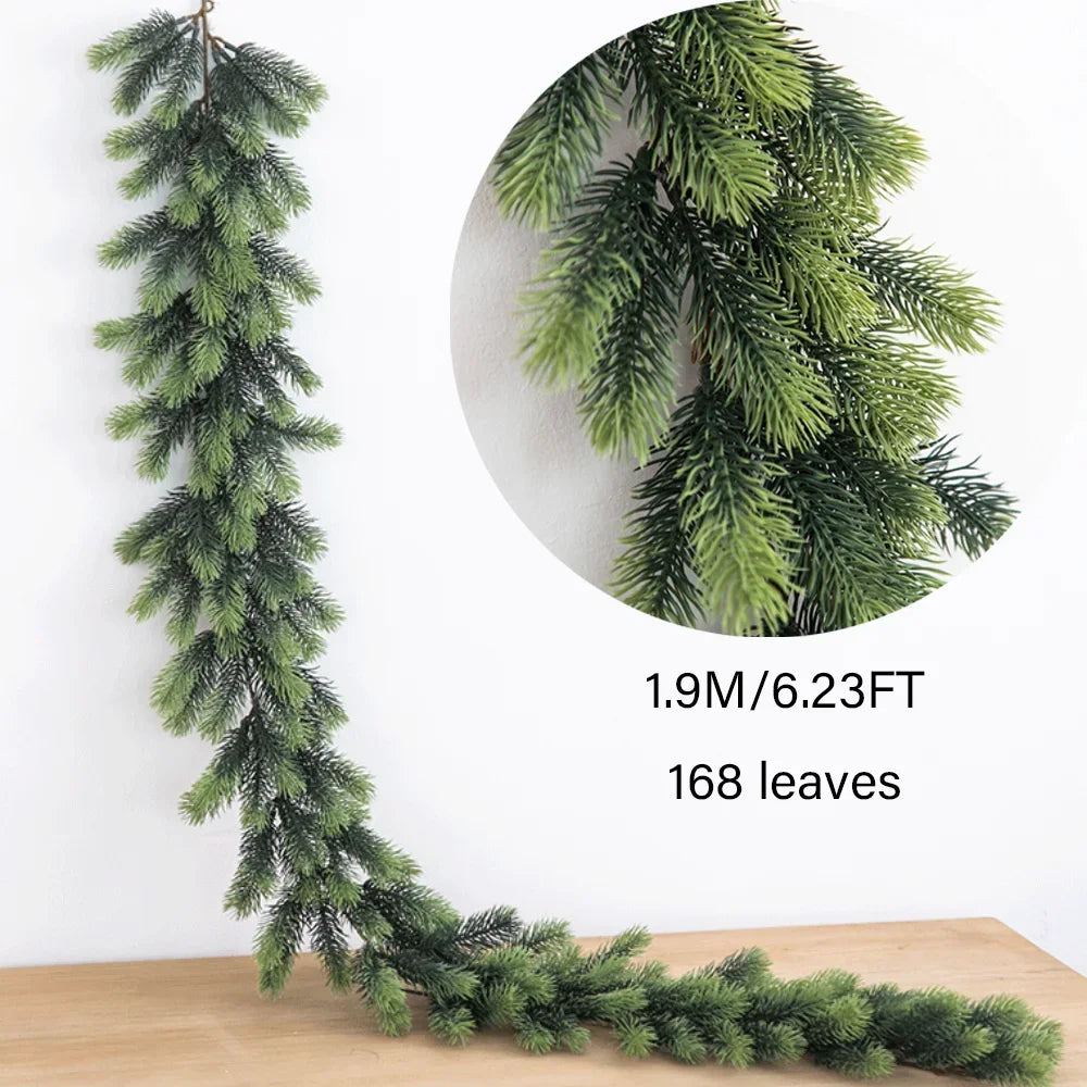 A long, green artificial pine garland with needles is displayed on a wooden surface.